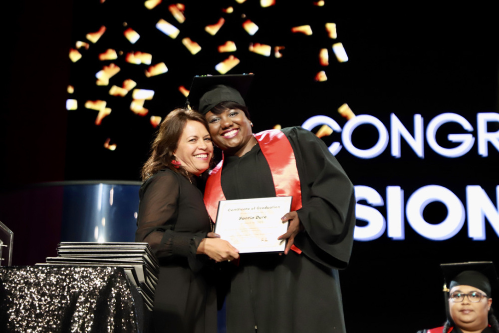 A student celebrates graduation from CrossPurpose, a training provider in the Colorado Pay It Forward Fund.